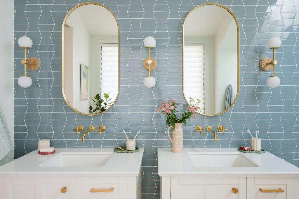 Bathroom with double sinks and blue tile