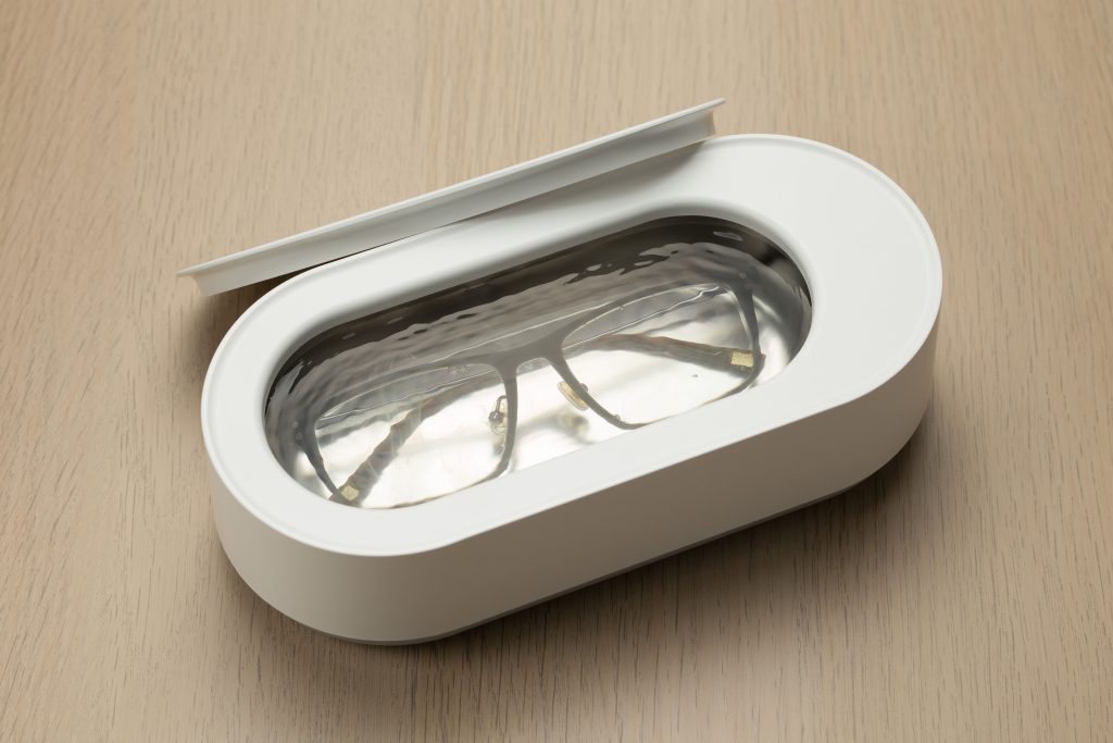 The Ultrasonic Smart Electric Glasses Cleaner in white, a revolutionary device designed to keep your eyewear spotless with advanced ultrasonic technology.